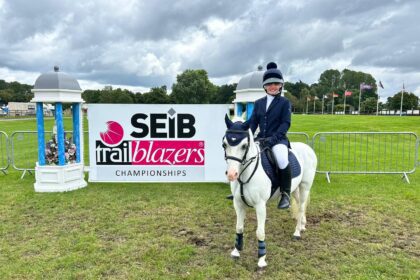 Grassroots competitor infront of SEIB branded backdrop